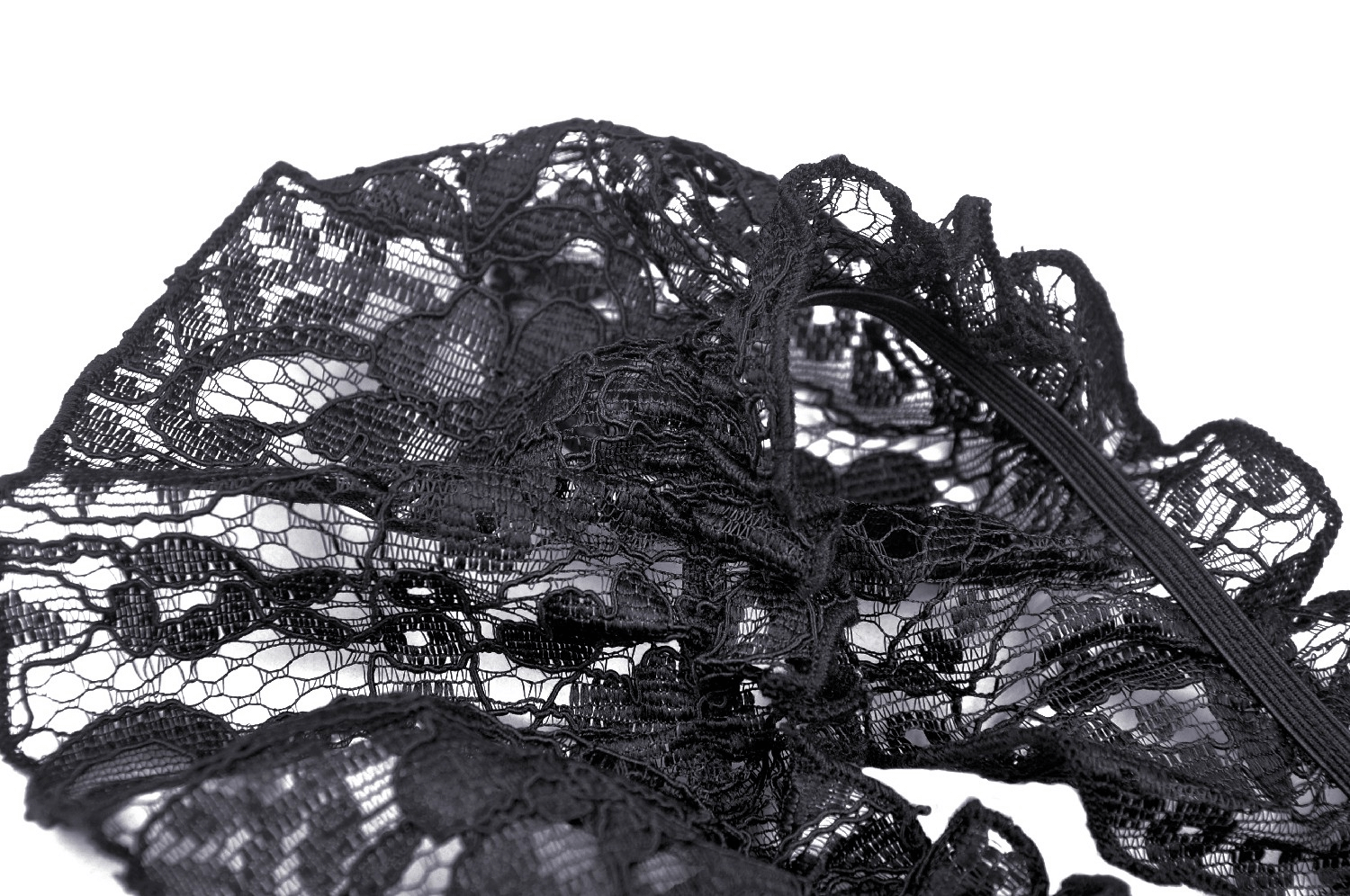 Elegant black lace fabric with intricate floral patterns and delicate ribbon accents for romantic attire.