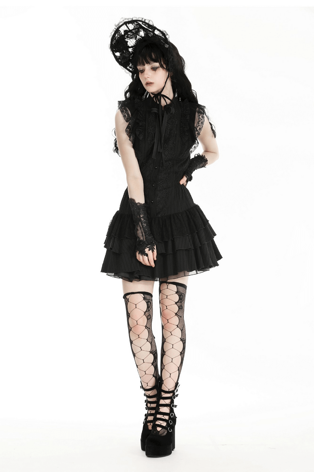 Chic woman in black lace dress and gloves, showcasing elegant gothic fashion with stylish accessories.
