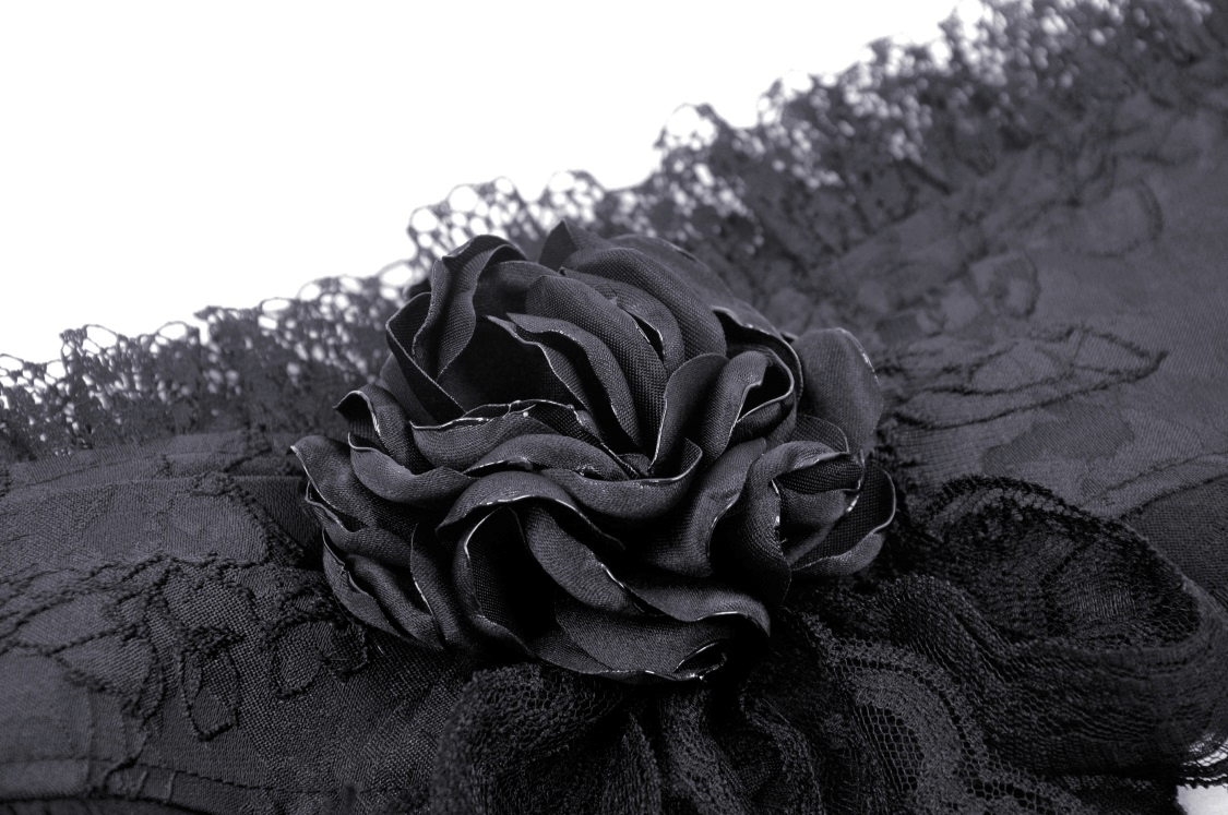 Close-up of elegant black lace with floral detailing, perfect for gothic-inspired fashion.