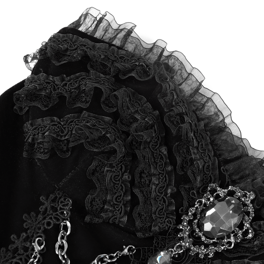 Elegant black lace evening dress detail with beads and chain embellishments, showcasing chic floral accents and intricate craftsmanship.