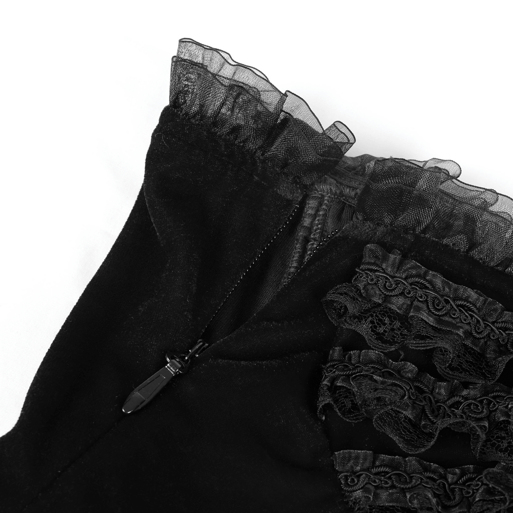 Close-up of black lace evening dress showing intricate beadwork and floral accents. Chic, elegant, and perfect for upscale events.