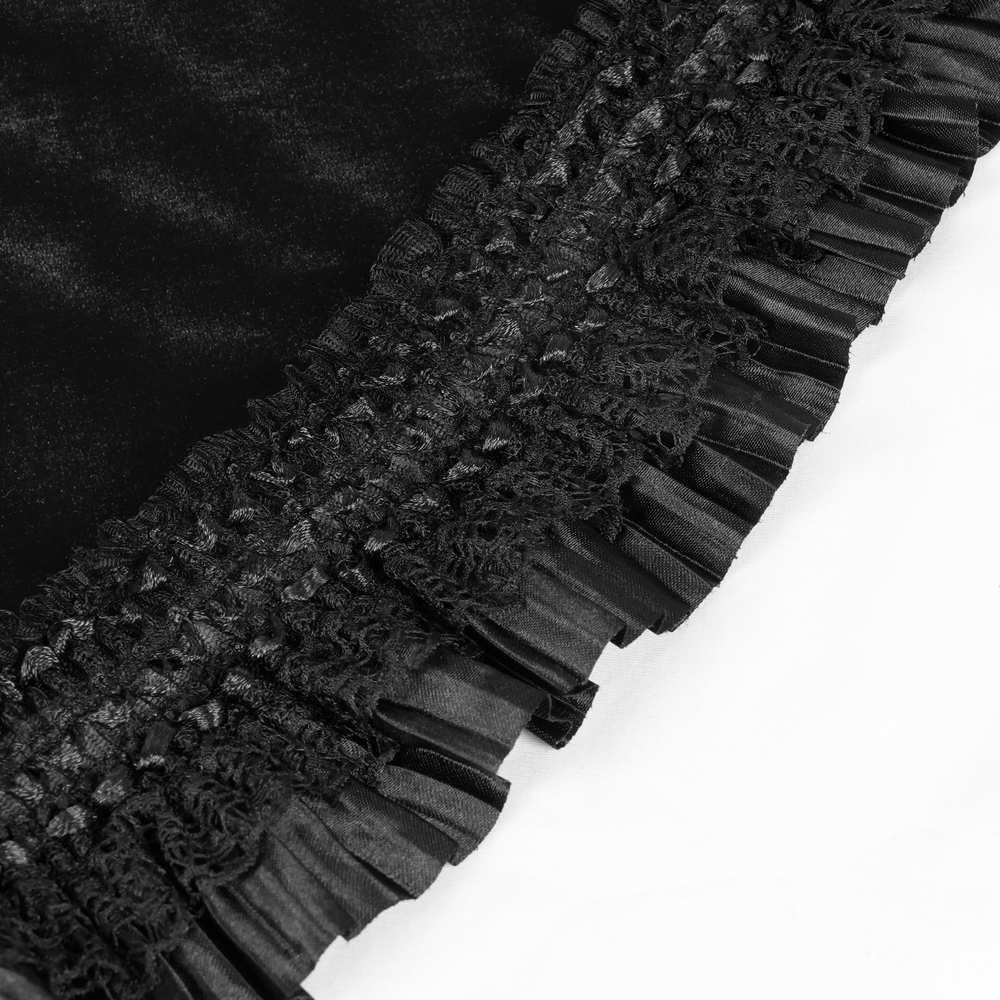 Close-up of elegant black lace evening dress with intricate floral details and chic ruffled edges