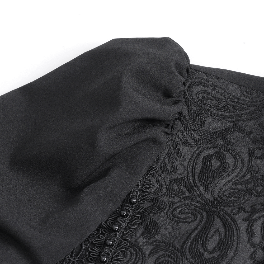 Close-up of elegant black lace detailing and soft fabric texture of a long sleeve gothic shirt for men.