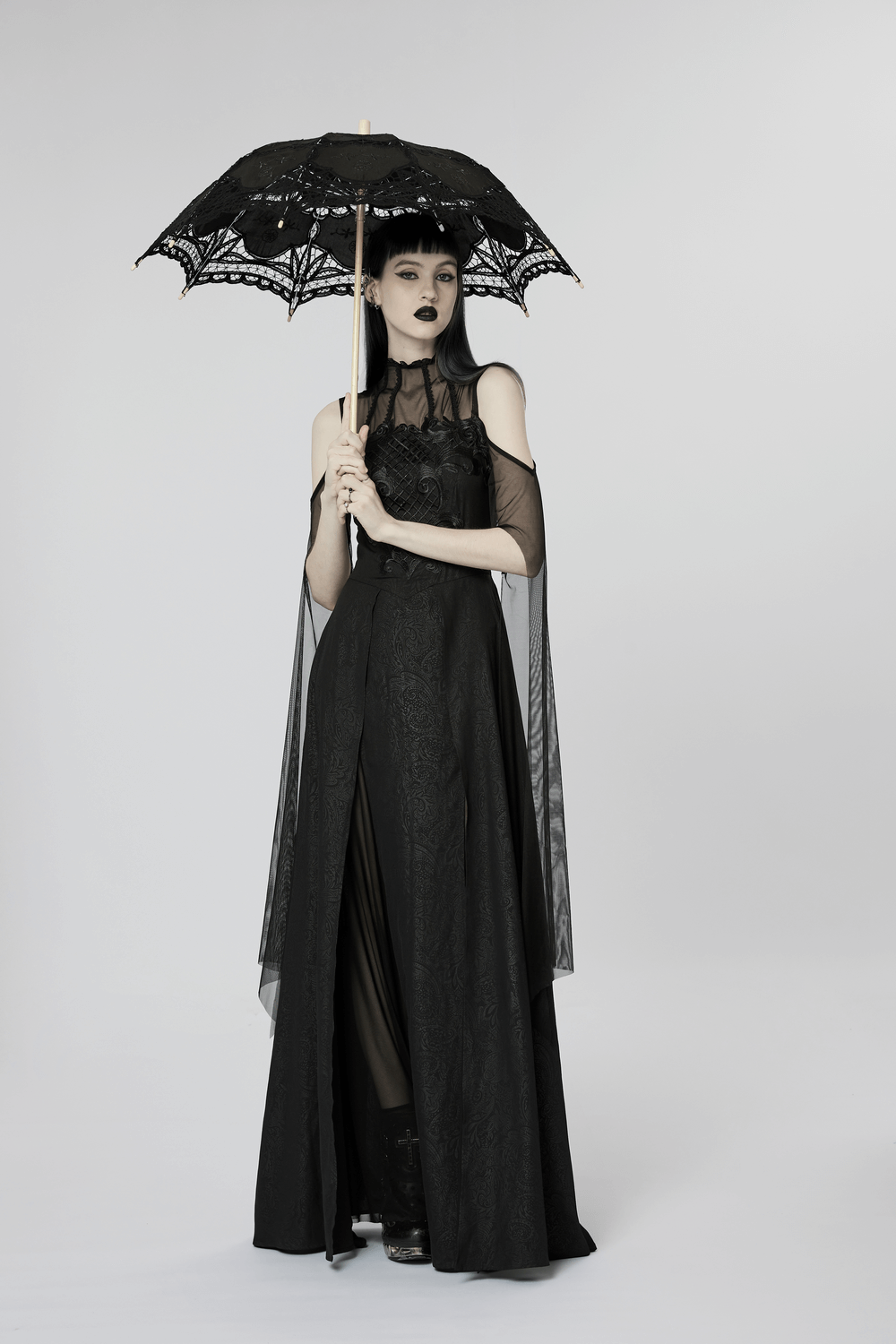 Elegant black lace off-the-shoulder long dress with a parasol, showcasing gothic charm and intricate designs.