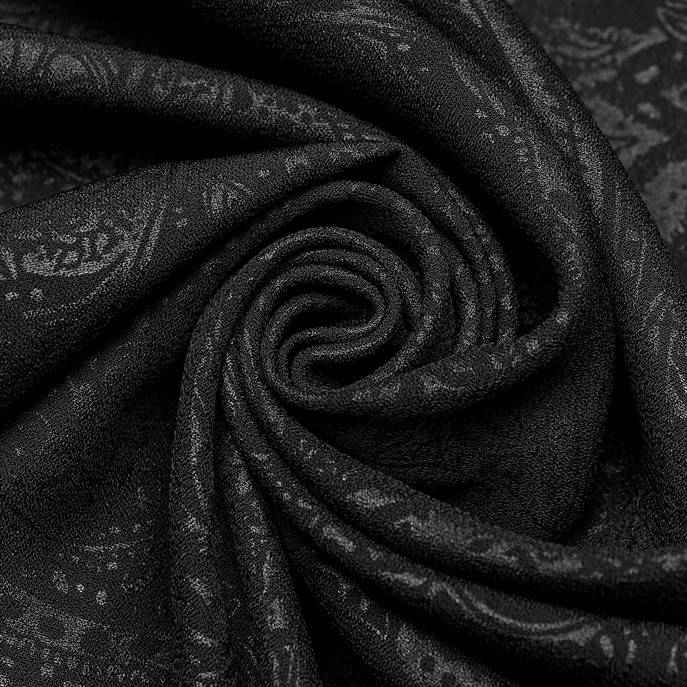 Close-up of luxurious black fabric with intricate patterns, perfect for elegant fashion design and gothic styles.