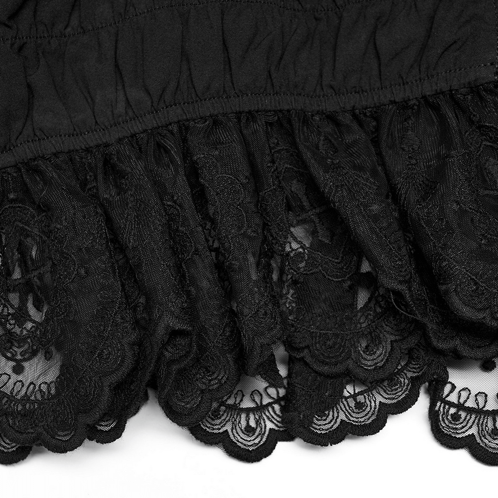 Close-up of delicate black lace ruffles showcasing intricate detailing and gothic elegance.