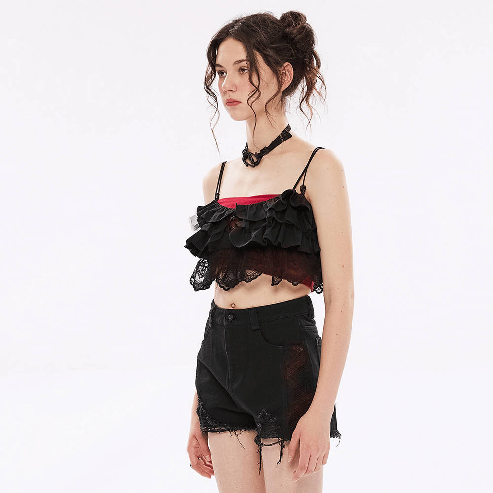 Model wearing an elegant black lace off-the-shoulder ruffle camisole with black shorts, showcasing a stylish gothic look.