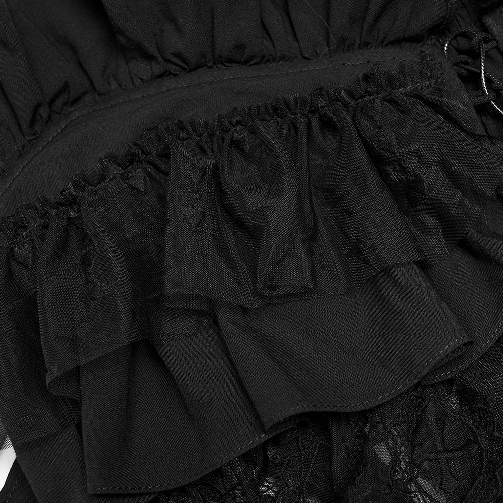 Close-up of black lace and ruffled detailing on an elegant off-the-shoulder top camisole.