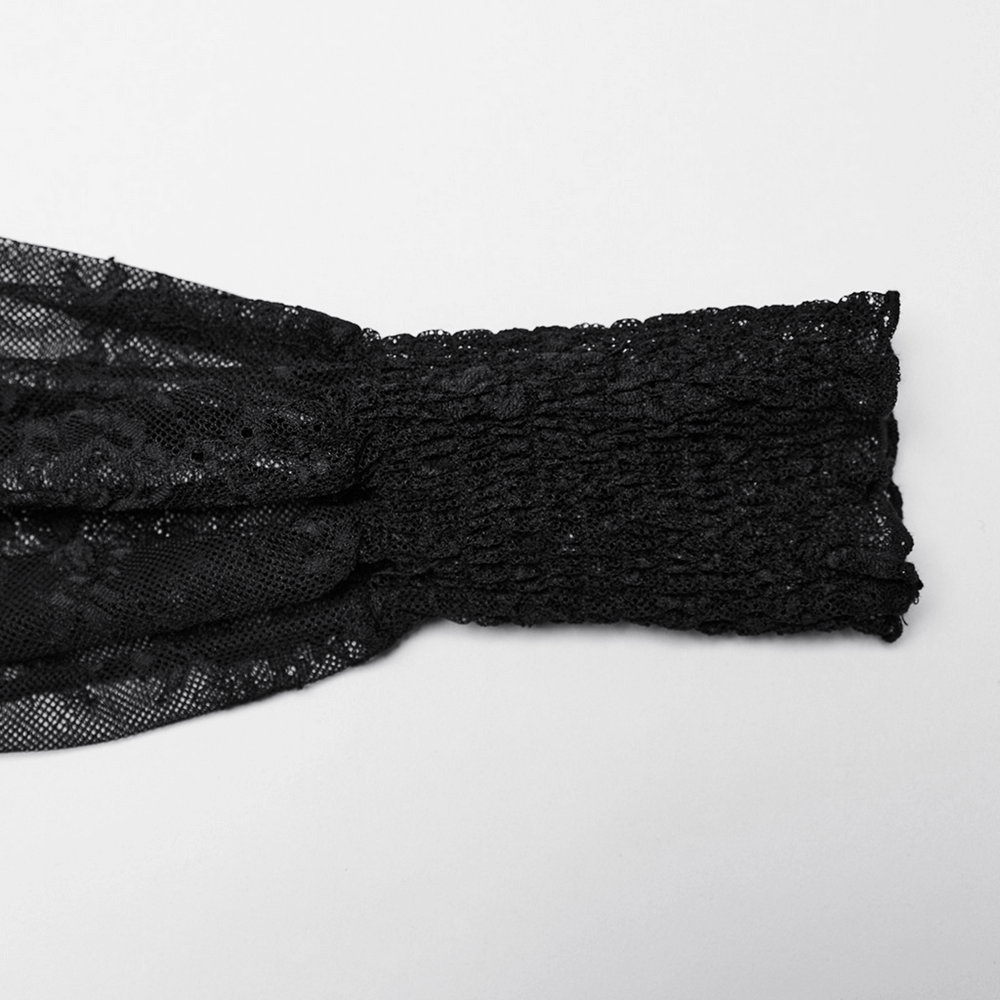 Close-up of black lace sleeve ruffle detail with smocked elastic, showcasing elegant texture and design for gothic fashion.