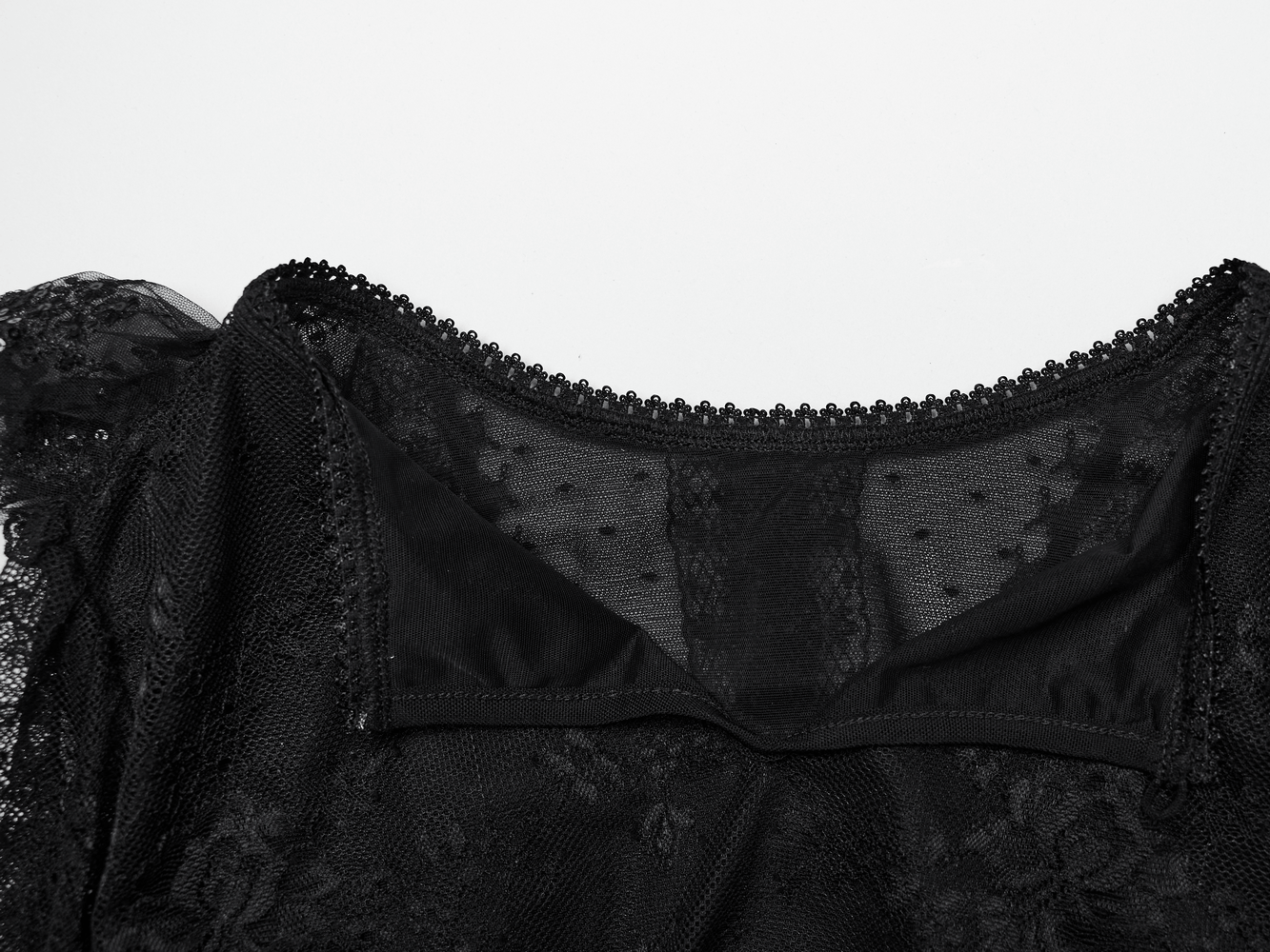 Elegant black lace blouse neckline featuring intricate detailing and soft mesh for a gothic chic look.