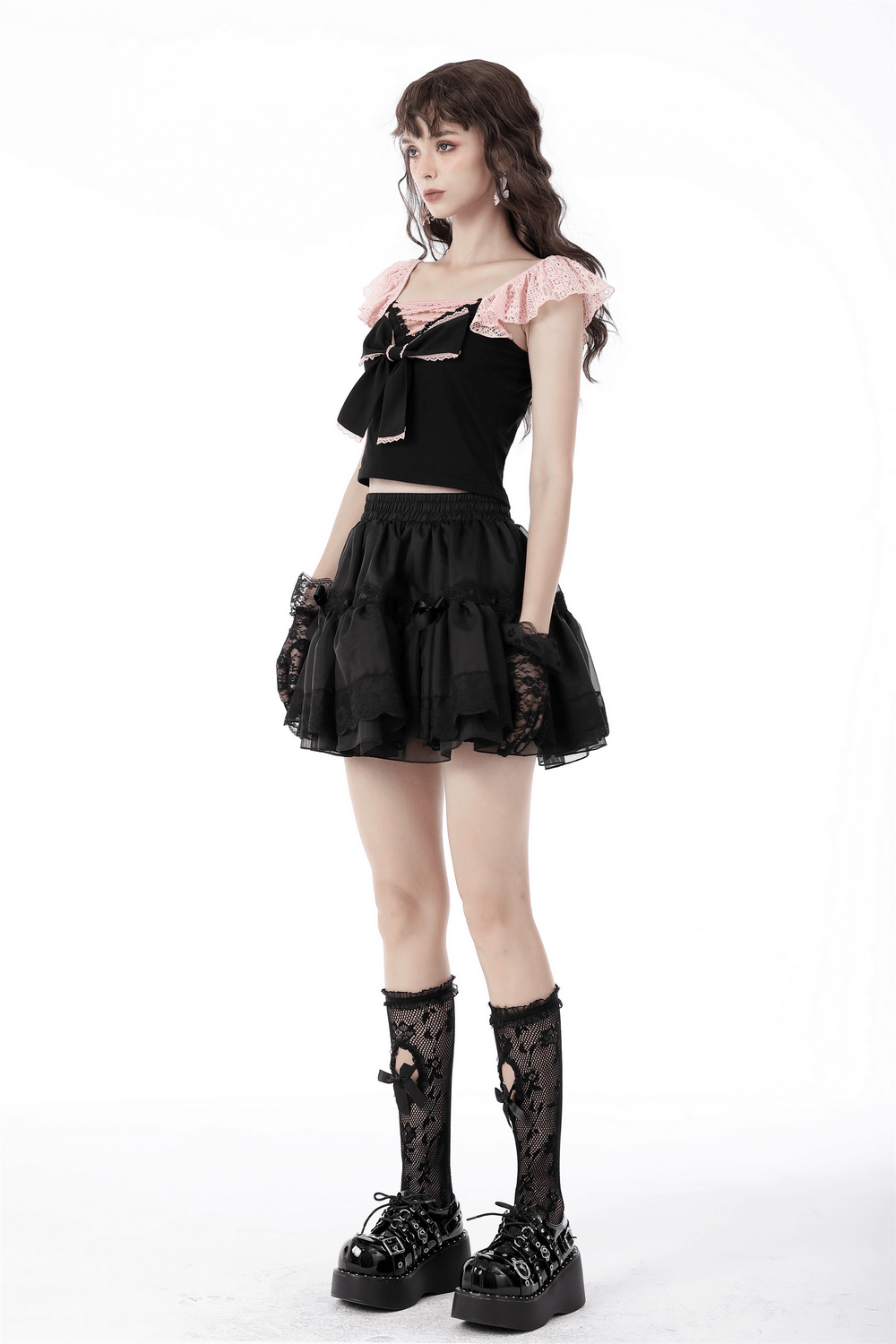 Gothic-inspired outfit featuring a black lace skirt with bows, paired with a stylish top and knee-high socks.