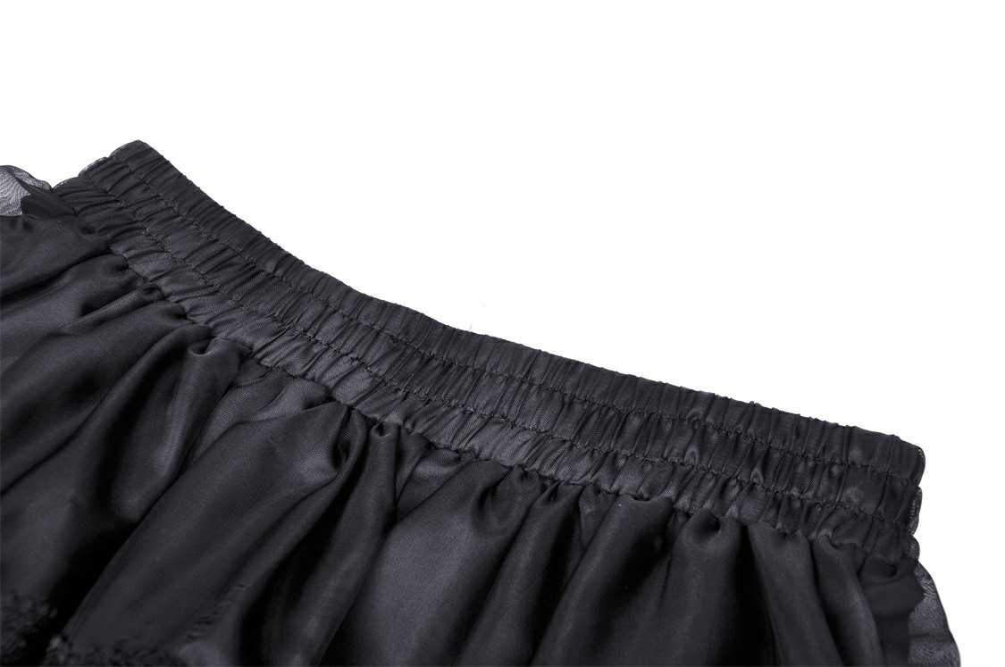 Close-up of the waistband of an elegant black lace skirt, showcasing soft fabric and intricate design details.