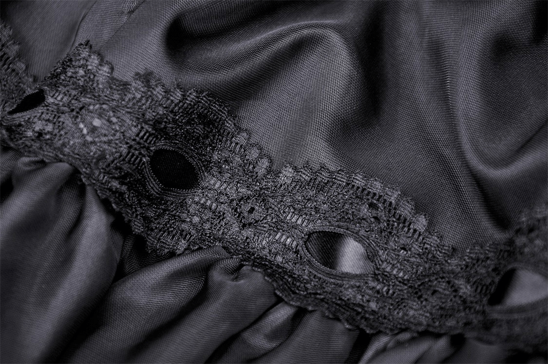 Close-up of elegant black lace with intricate patterns on silky fabric, ideal for gothic-style evening wear.