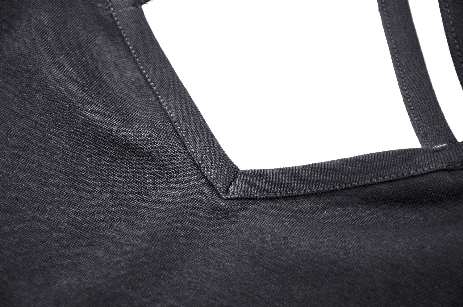 Close-up of the neckline and lace detail of an elegant black off-shoulder mini dress.