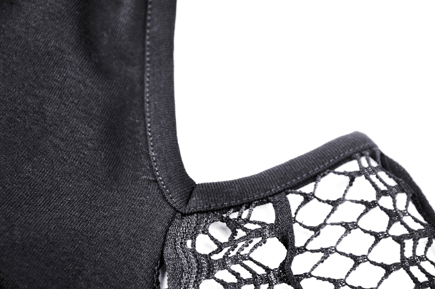 Close-up of elegant black dress with intricate lace sleeve detail, showcasing chic off-shoulder design.