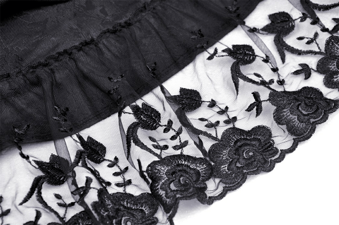 Close-up of elegant black lace detailing on tiered evening dress, perfect for special events and night outings.