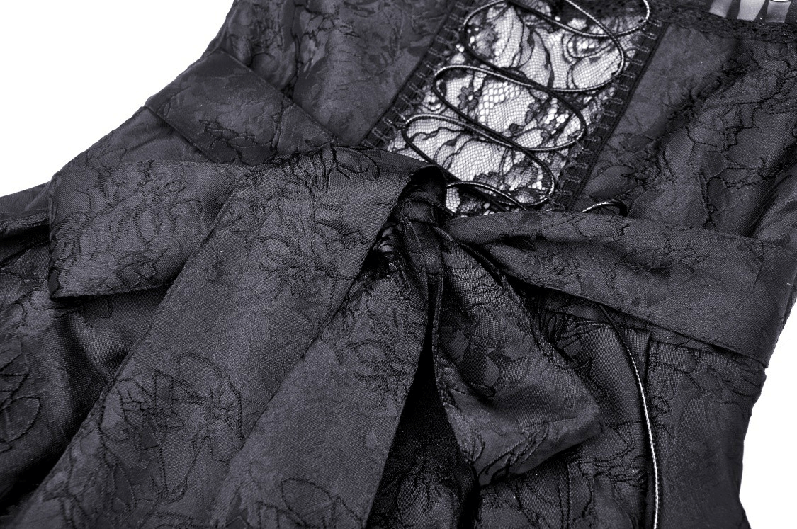 Close-up of elegant black lace tiered dress, featuring intricate lace detailing and a stylish bow.