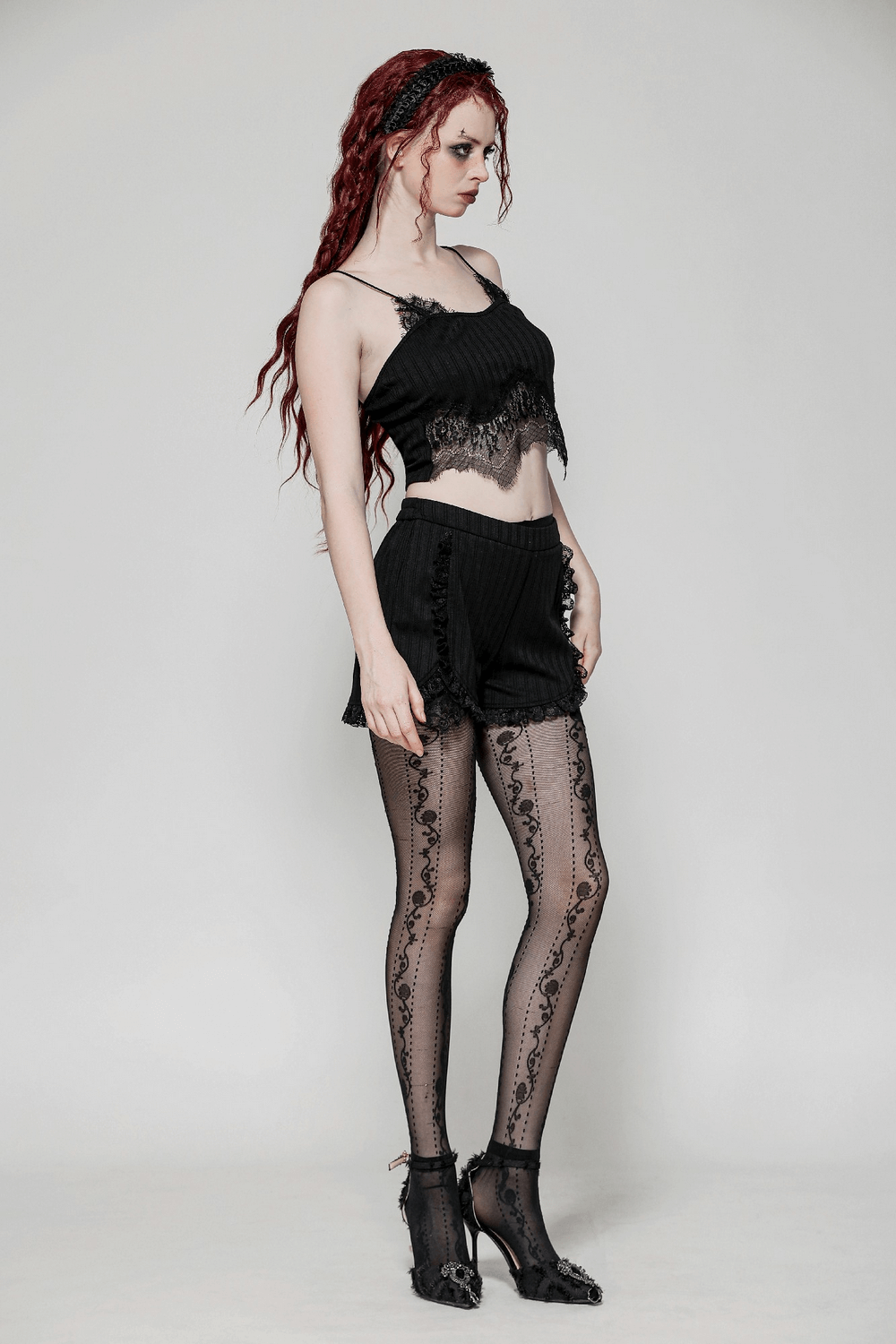 Gothic black lace trimmed ribbed camisole top paired with stylish shorts and sheer lace tights.