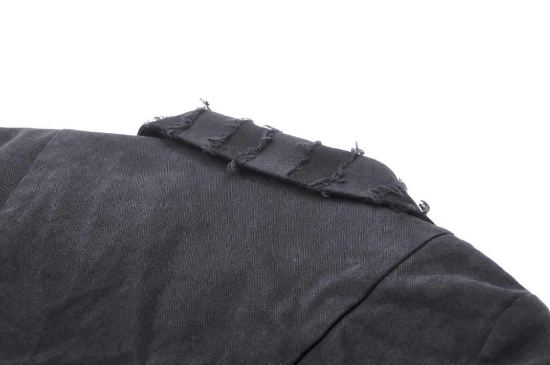 Close-up of an elegant black coat's shoulder with stylish frayed details, showcasing contemporary edge and design.
