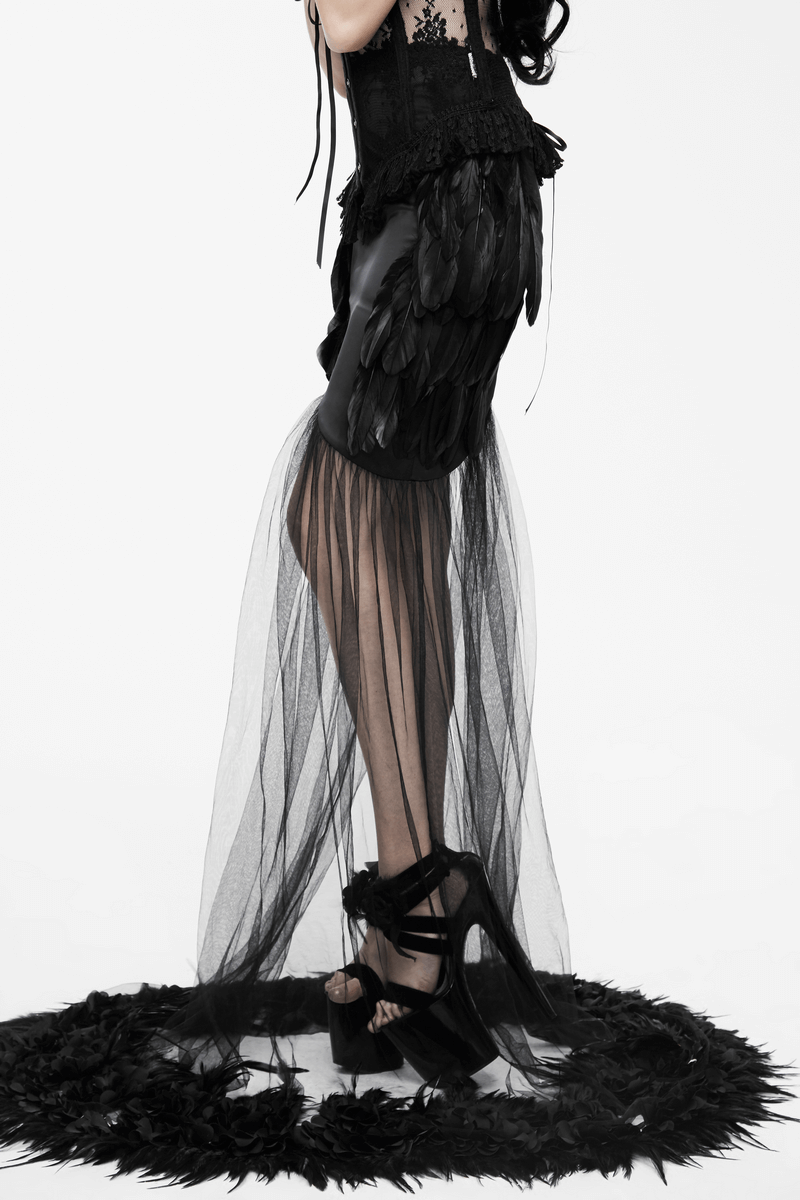 Stylish black long skirt with flared mesh overlay, gothic style, paired with strappy heels. Perfect for edgy fashion lovers.