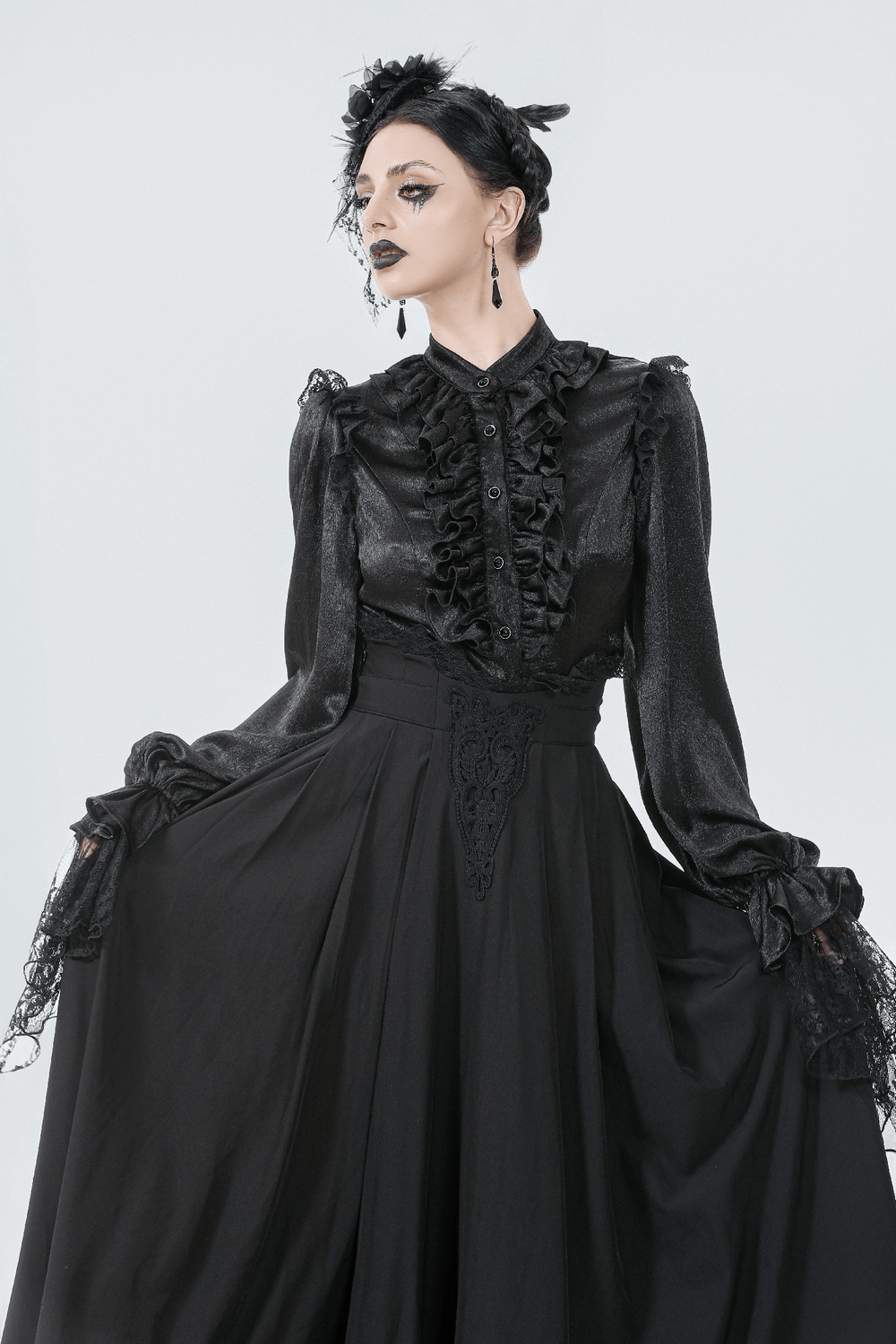 Elegant Black Maxi Skirt with Lace Back and Bow Detail worn by a model in a striking black blouse.