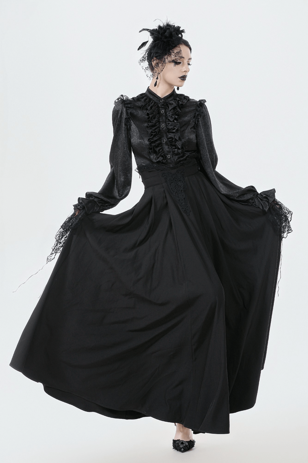 Elegant Black Maxi Skirt with Lace Back and Bow Detail worn by a model in a studio setting.
