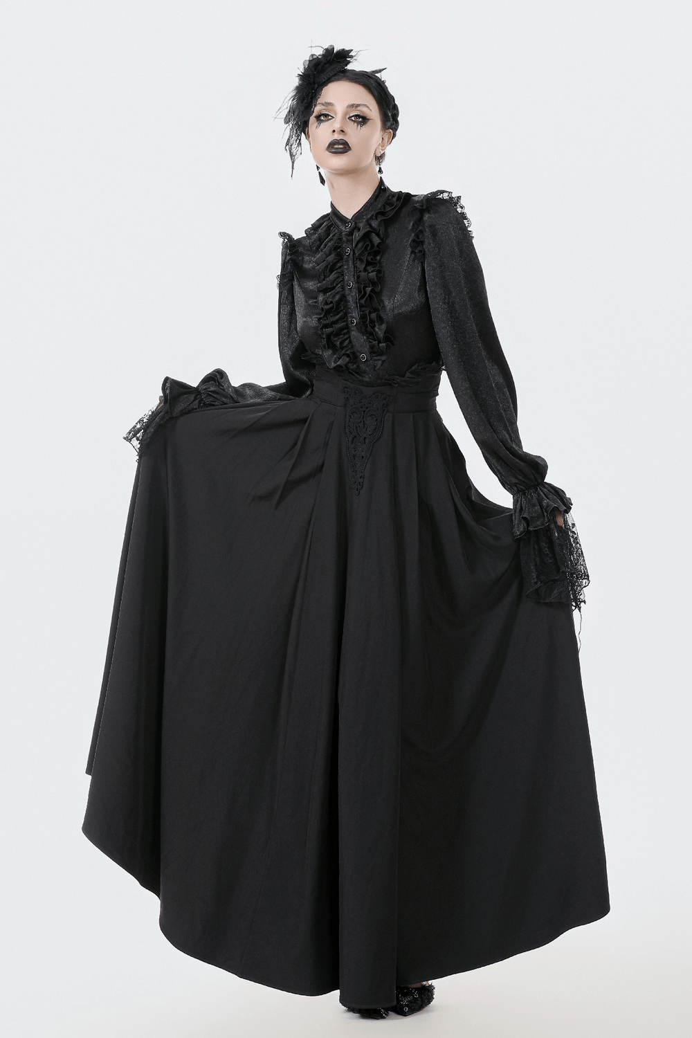 Elegant Black Maxi Skirt with Lace Back and Bow Detail worn by a model in a stylish, dark-themed setting.