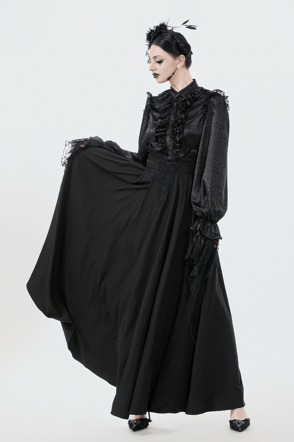Elegant Black Maxi Skirt with Lace Back and Bow Detail worn by model in elegant setting.