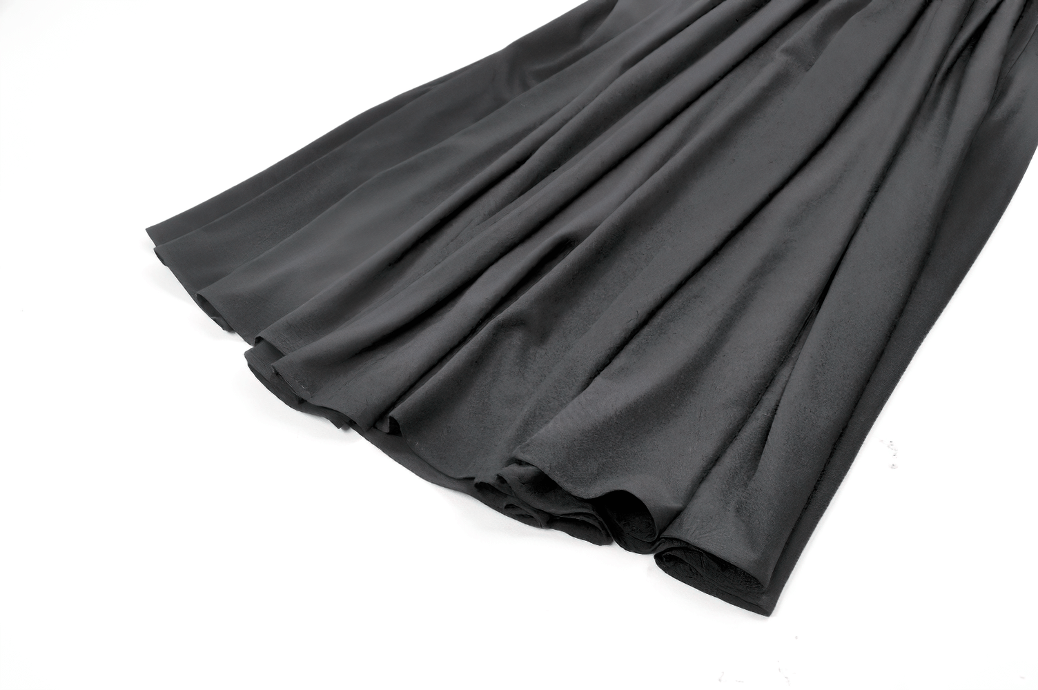 Elegant Black Maxi Skirt with Lace Back and Bow Detail fabric close-up showcasing soft, flowing black material.