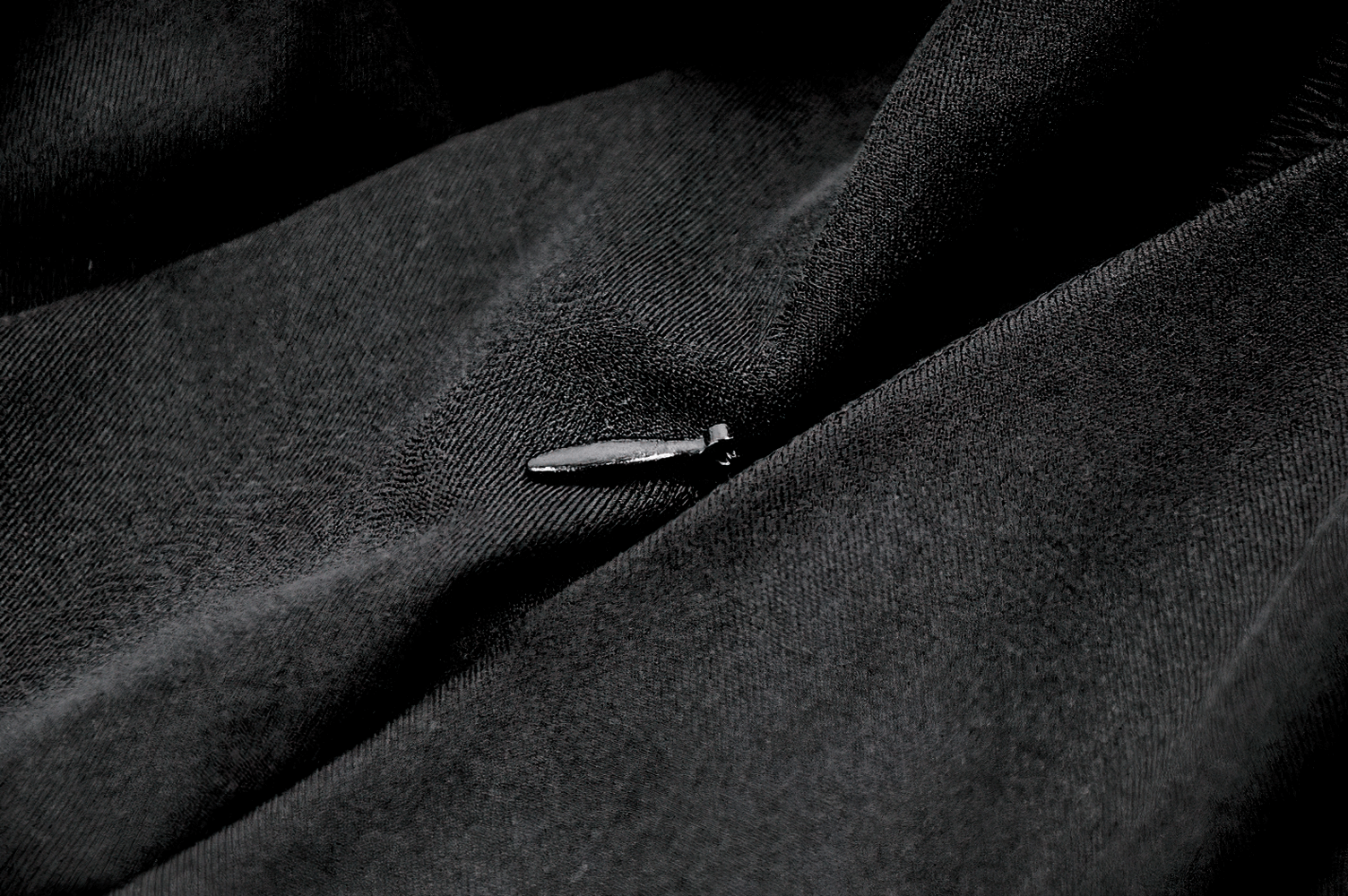 Elegant Black Maxi Skirt with Lace Back and Bow Detail fabric close-up showing texture and detail.