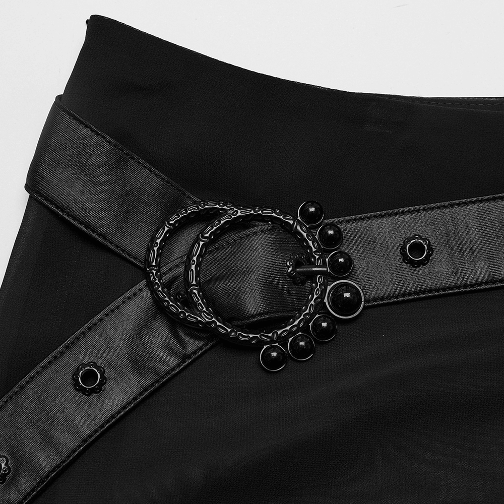 Close-up of a stylish black belt with double ring buckle on a sheer chiffon maxi skirt.