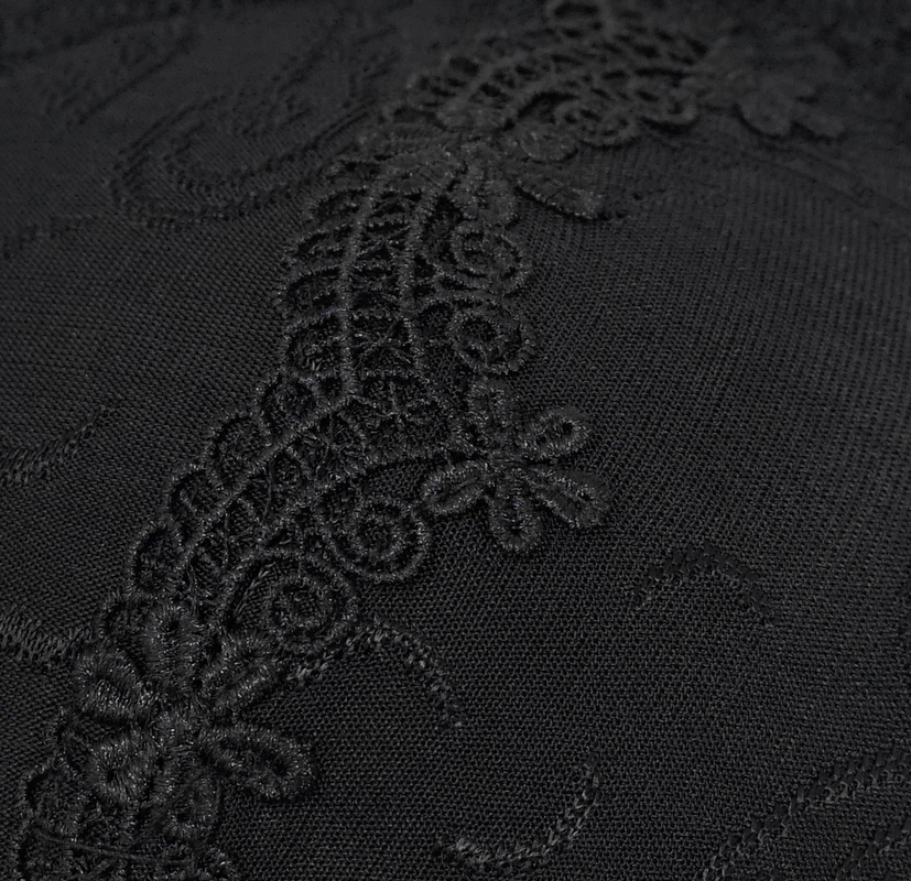 Close-up of elegant black fabric with intricate brocade detailing, perfect for gothic-style swimsuits.