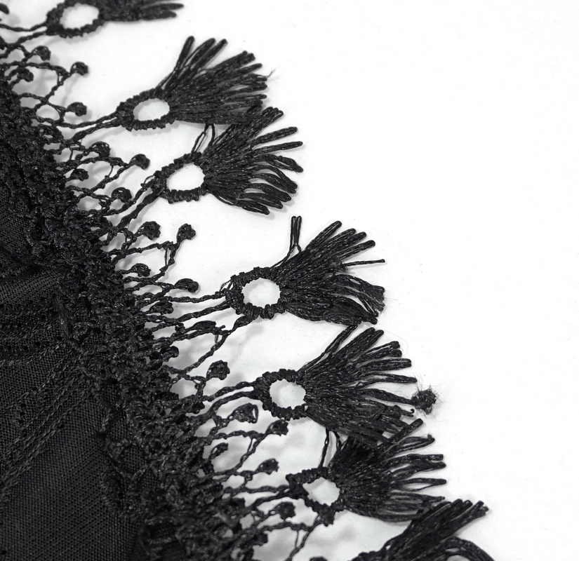 Close-up of intricate black fringe lace detailing on gothic-style women's swimsuit.