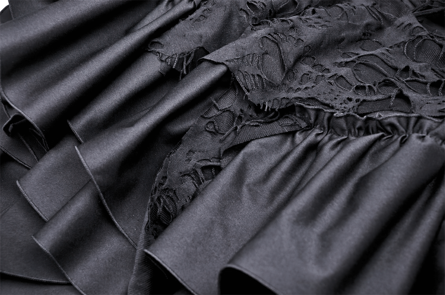 Close-up of the elegant black dress featuring intricate lace and asymmetrical ruffles for a gothic vibe.