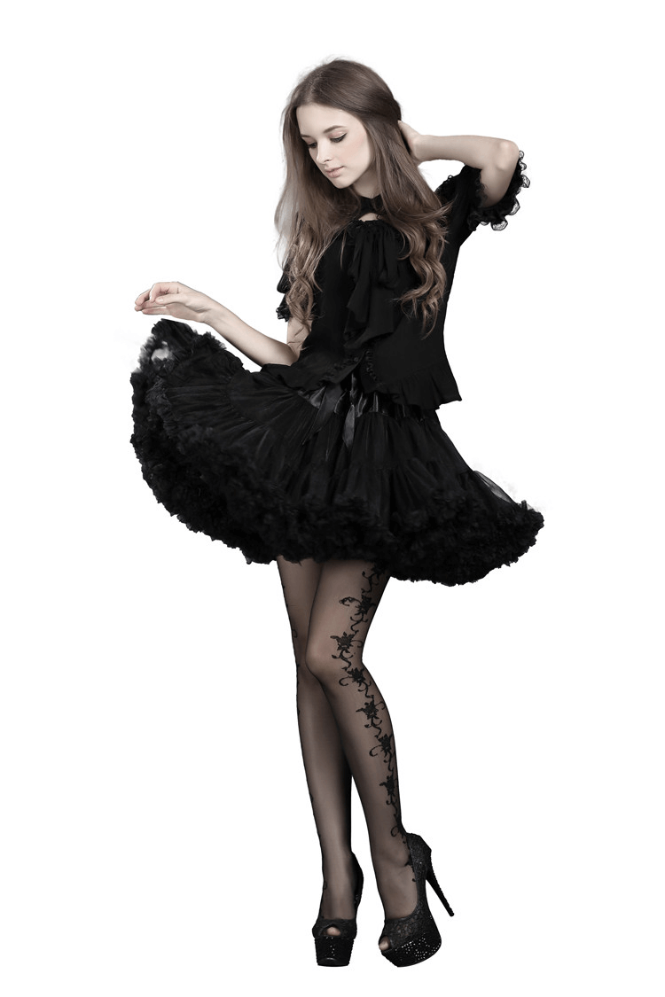 Chic model wearing an elegant black tulle skirt with satin waistband and a stylish black bow, showcasing an evening look.