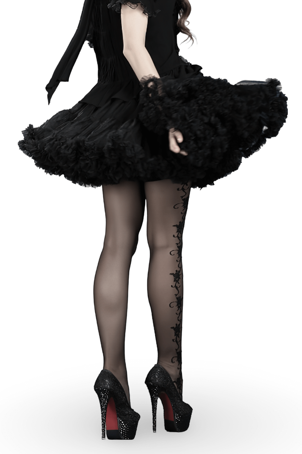 Chic woman twirling in a layered black tulle skirt with satin waistband and elegant high heels.