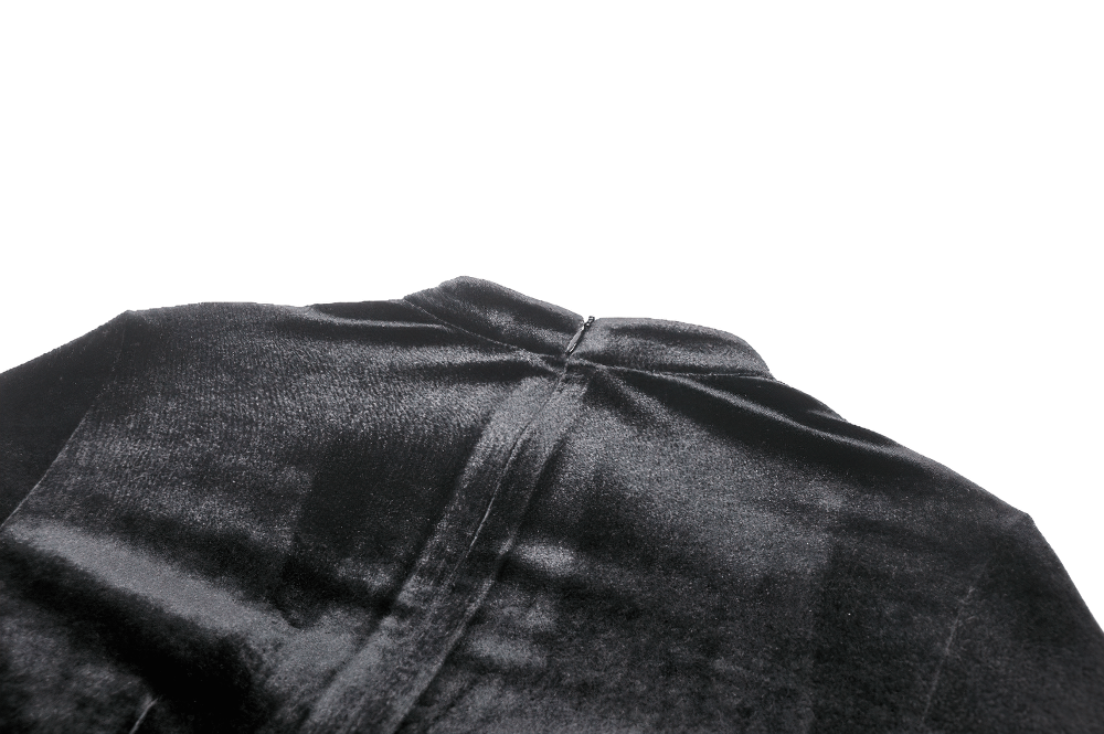 Close-up of the back neckline of an elegant black velvet dress, showcasing its luxurious fabric and design.
