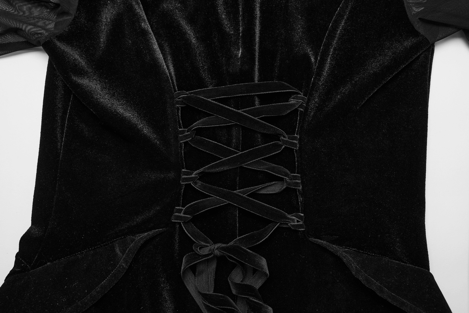 Close-up of the lace-up back design on an elegant black velvet mesh dress for a customizable fit.