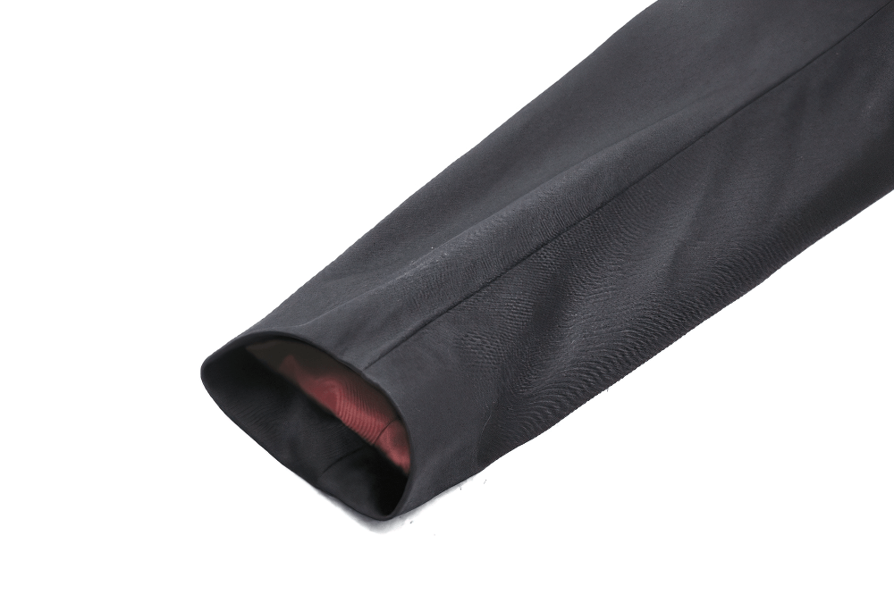 Close-up of the sleeve lining of an elegant black Victorian coat, showcasing luxurious satin in deep red.