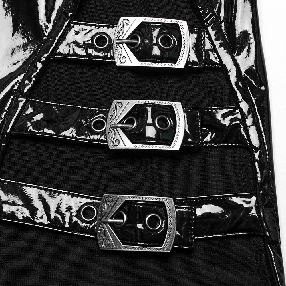 Close-up of shiny black faux leather dress featuring stylish metal buckles and edgy design elements.