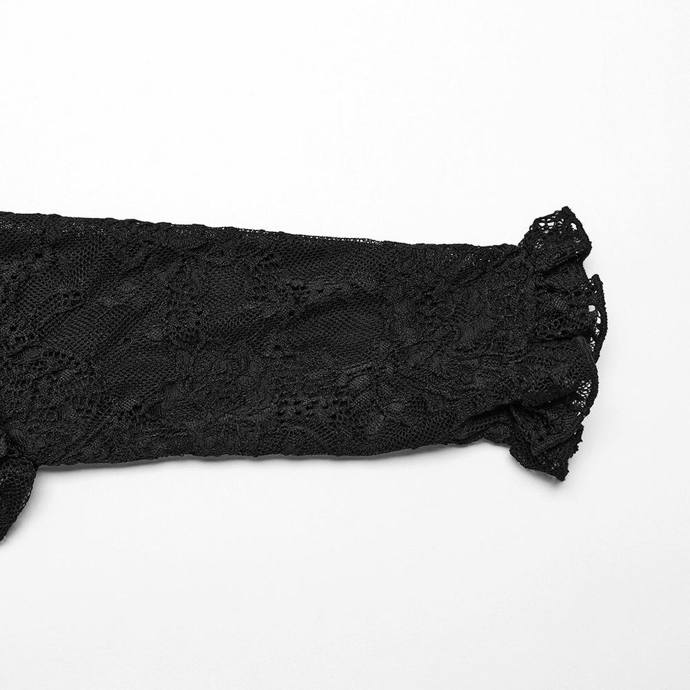 Close-up of the elegant black lace sleeve from a gothic blouse, showcasing intricate textures and ruffled cuffs.