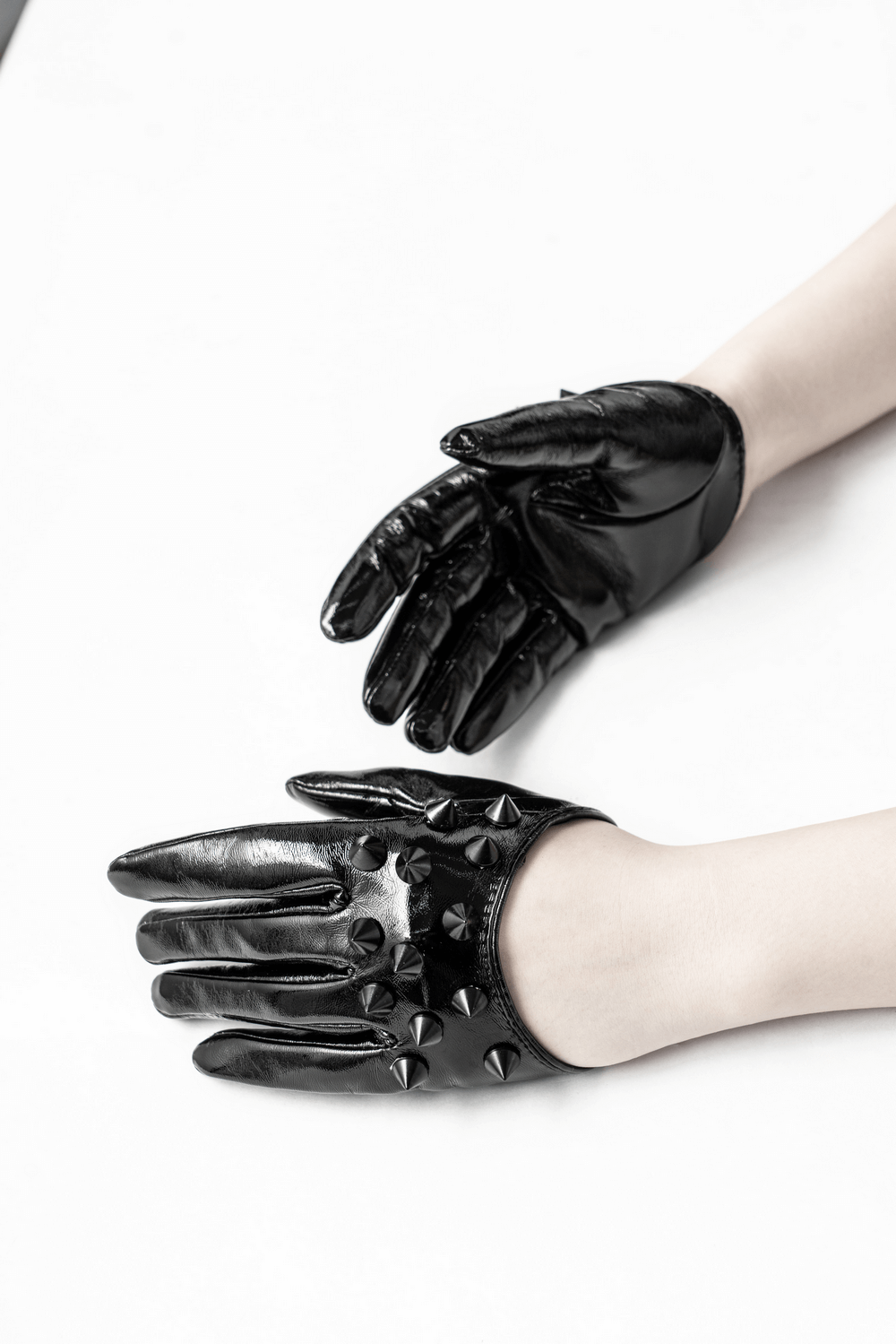 Stylish black spiked punk half-hand gloves with rivet studs, perfect for punk rock fashion.