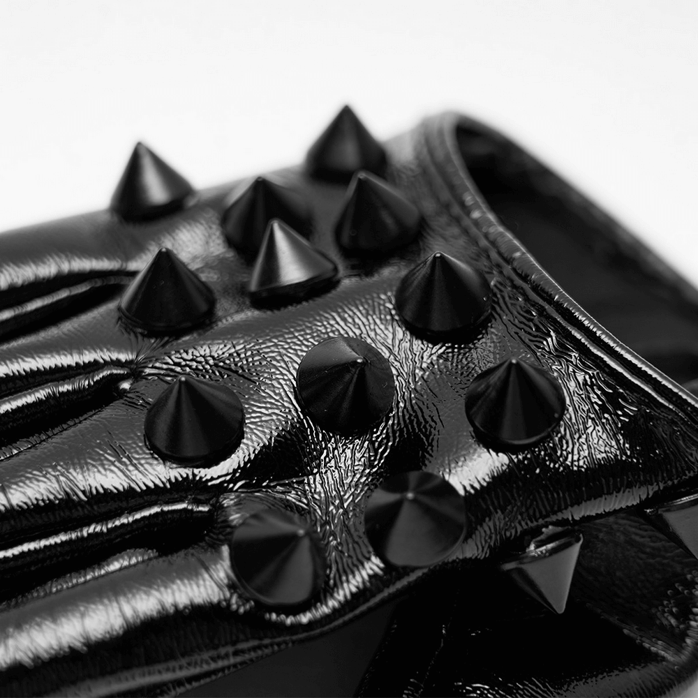 Close-up of black spiked punk half-hand gloves featuring shiny rivet studs for a bold, edgy style.