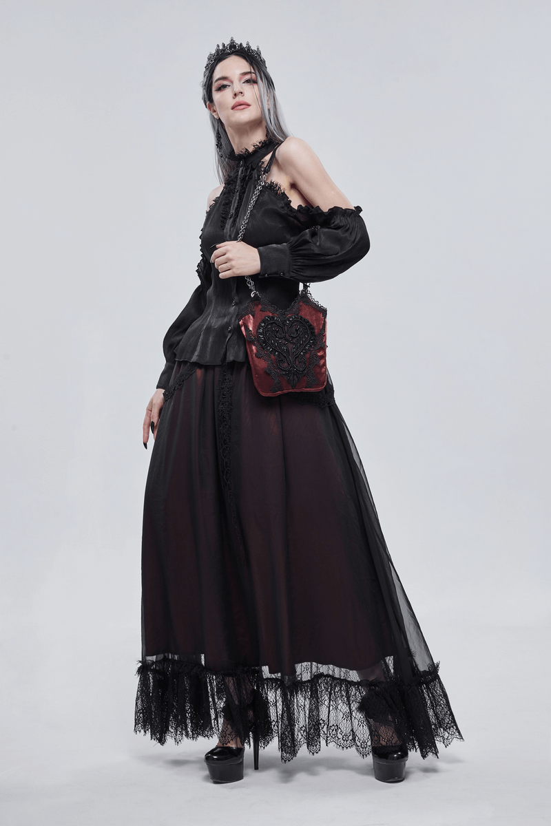 Woman in gothic style dress with an elegant red floral bucket bag featuring black guipure and chain accessory.