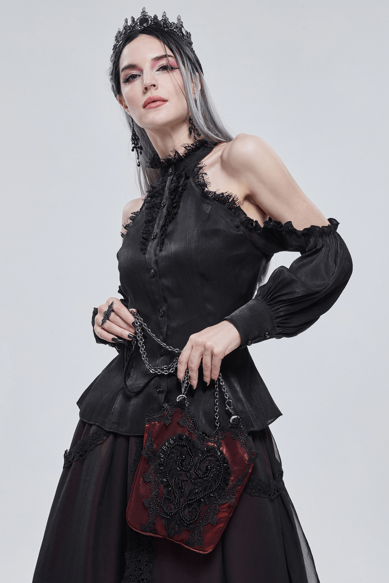 Elegant gothic woman in black blouse holding floral bucket bag with guipure and chain, adding a dark romantic touch.