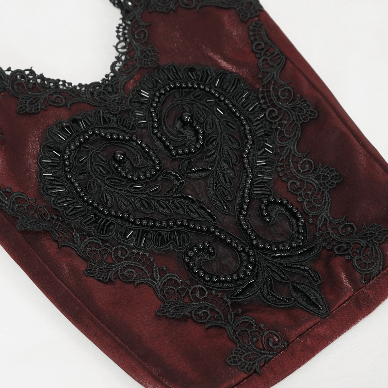 Close-up of elegant red bag featuring intricate black guipure design and embellishments, perfect for gothic fashion.