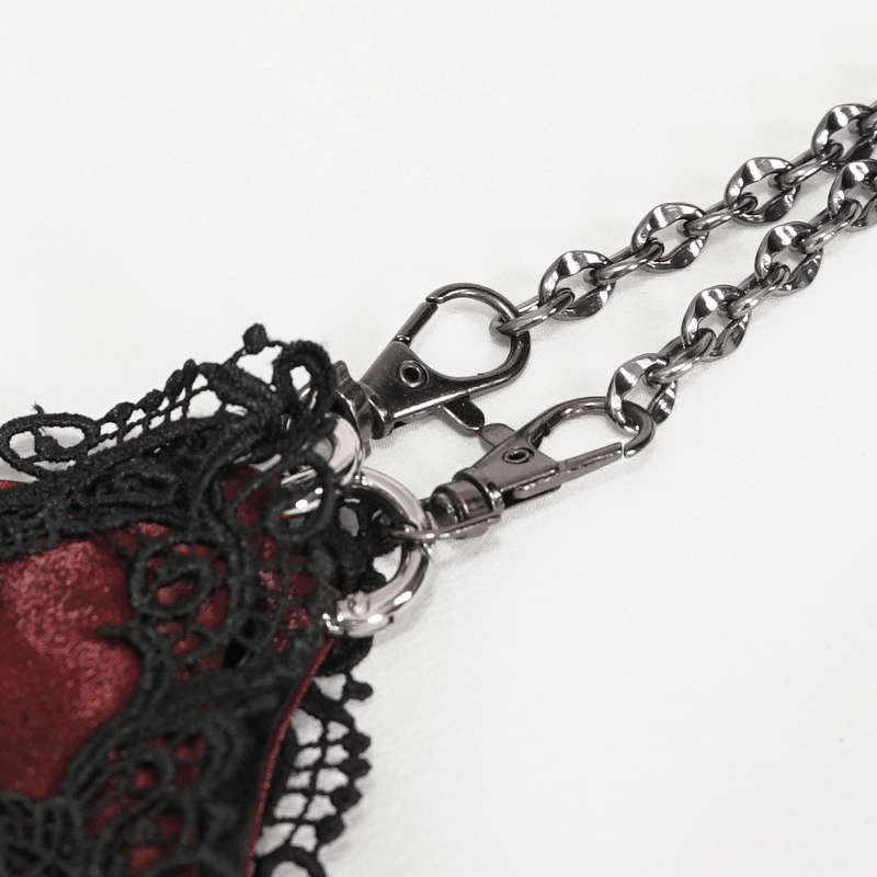 Close-up of black guipure lace and elegant chain detail on a women's red gothic bucket bag.