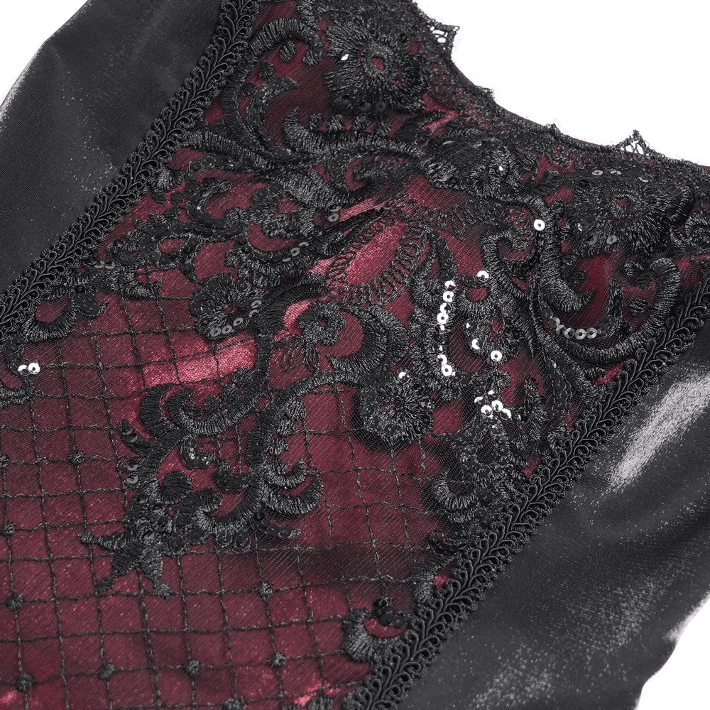 Close-up of intricate black lace embroidery over deep red fabric with shimmering beaded accents, perfect for gothic fashion.