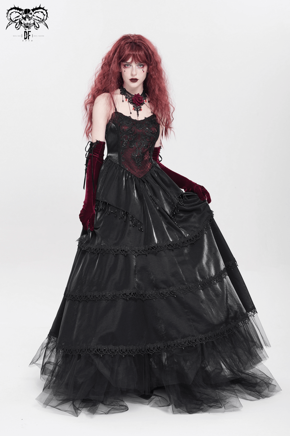 Gothic Victorian maxi dress with corset bodice, layered skirt, lace trim, and beaded accents in deep red and black.