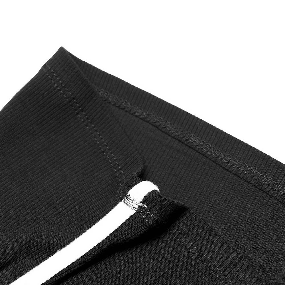 Close-up of the elegant elastic pit strip and stitching on a black camisole, showcasing fine design details.